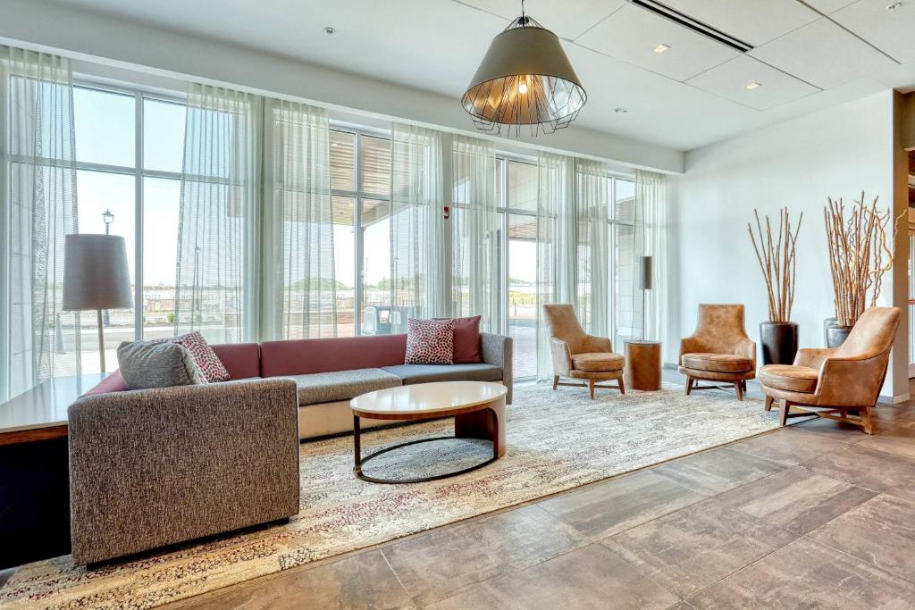 a living room with a couch and chairs at Courtyard by Marriott North Brunswick in North Brunswick