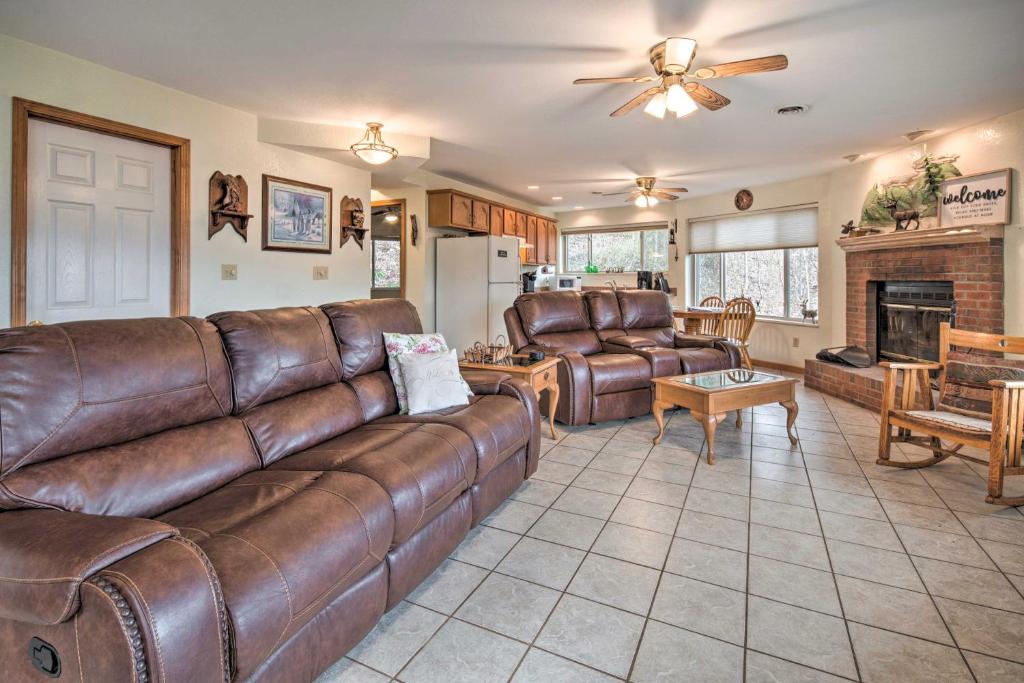 a living room with a brown leather couch at Apt in Pisgah Natl Forest! Fireplace and Mtn Views in Burnsville