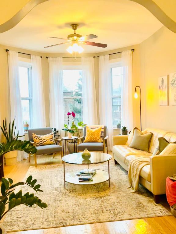 a living room with couches and a coffee table at Sunny, Spacious, 3BR 1BA Davlin INN Chicago in Chicago
