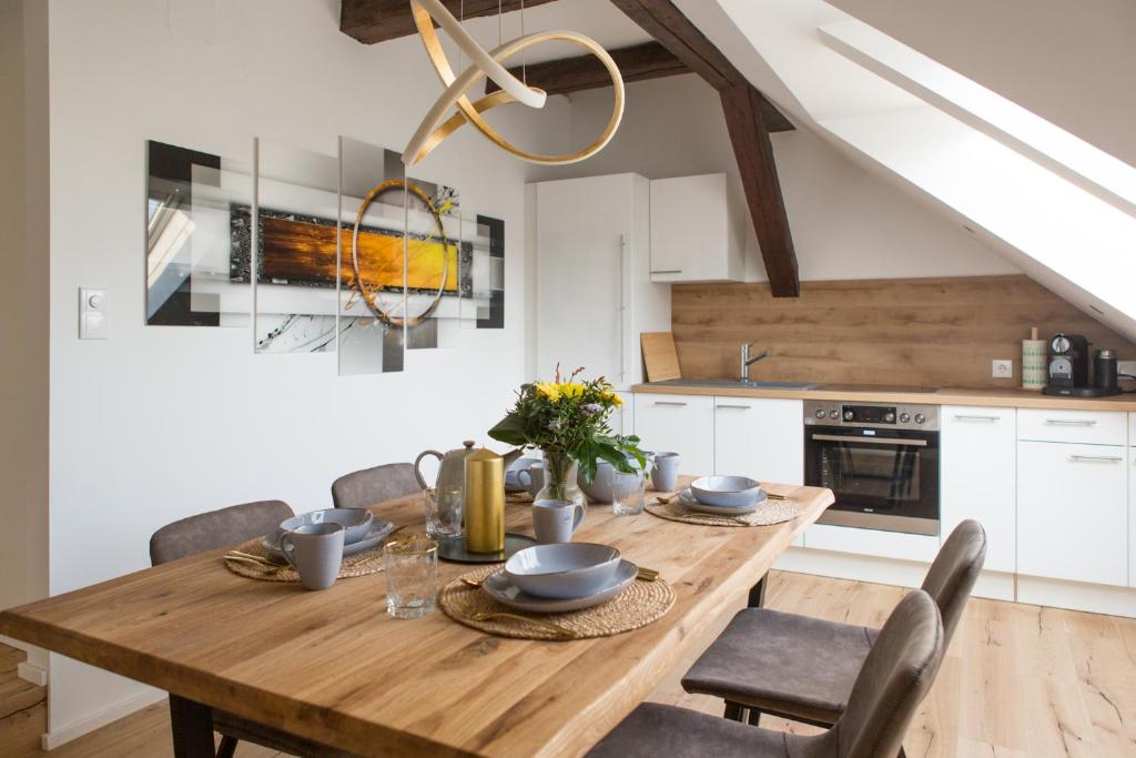 a dining room with a wooden table and chairs at Modern City Apartment in Graz