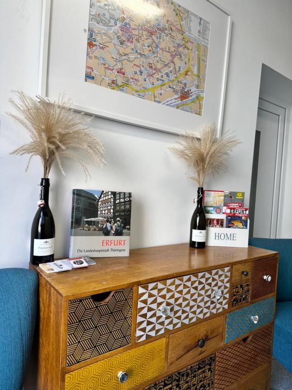 a wooden dresser with two bottles of wine on top at Gästehaus Glücksmoment in Erfurt