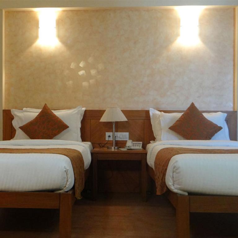 Postel nebo postele na pokoji v ubytování Hotel Abigail Regency