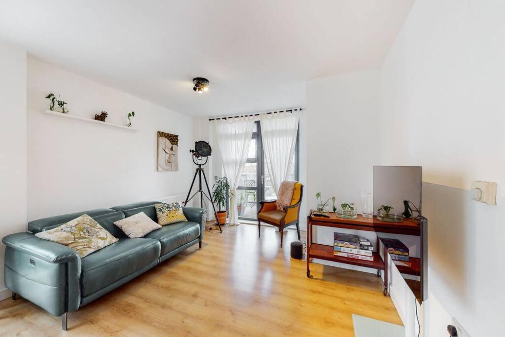 a living room with a couch and a table at Modernistic 2-bedroom flat in Shadwell in London