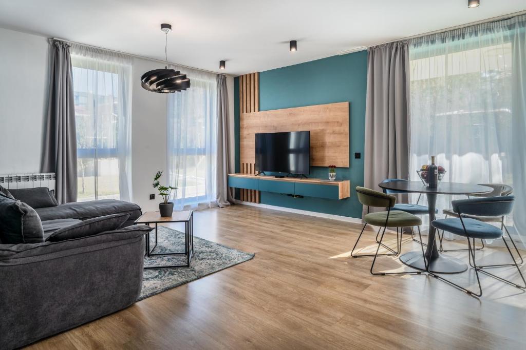 a living room with a couch and a table at Paradise Luxury Apartments in Sofia