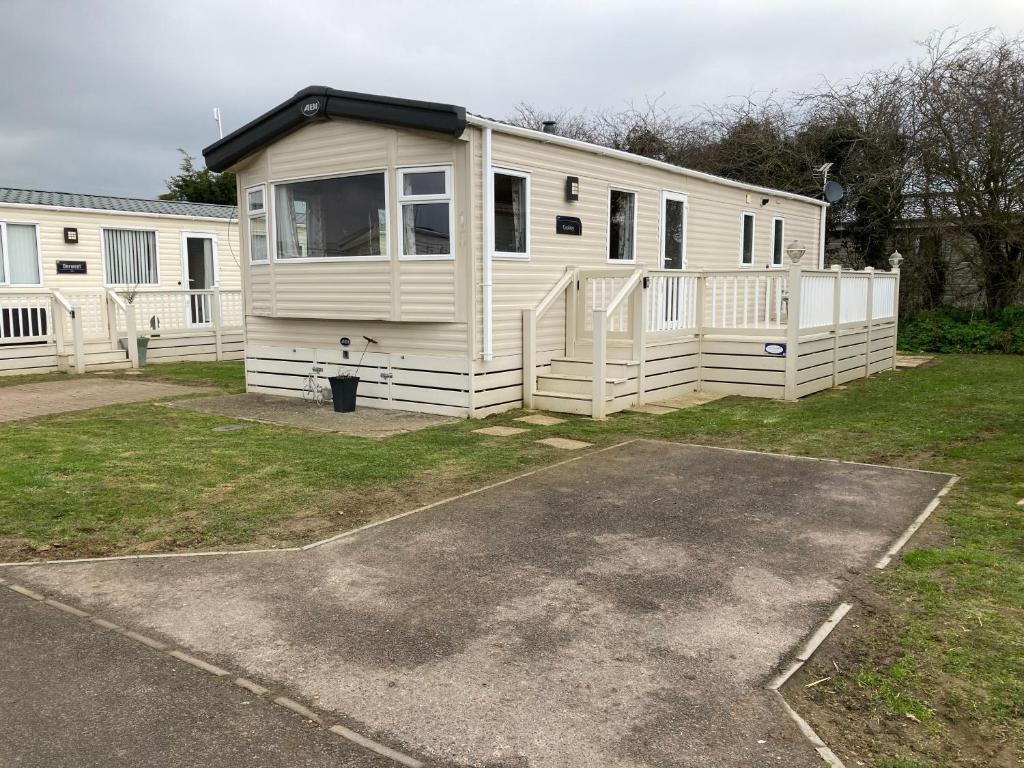 a white mobile home parked in a parking lot at Birchington vale caravan holiday park in Kent