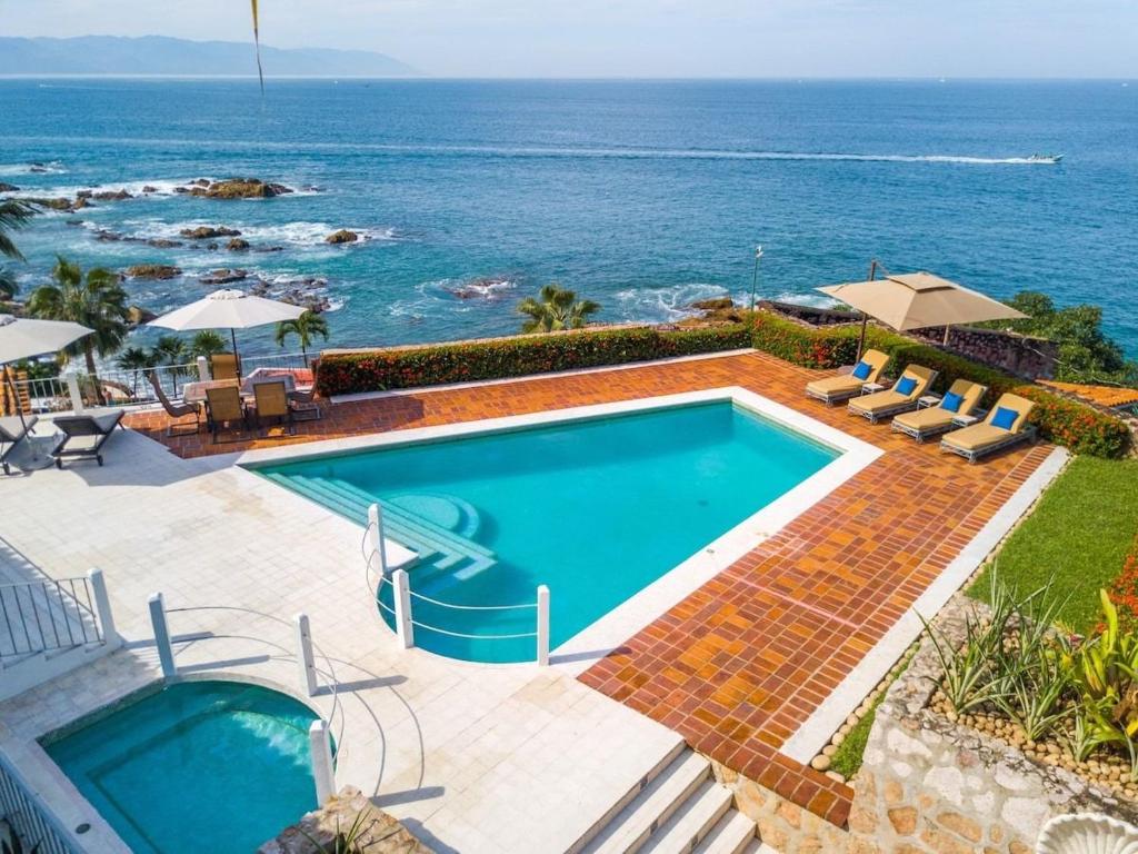 a swimming pool with a view of the ocean at Casa Lido in Puerto Vallarta