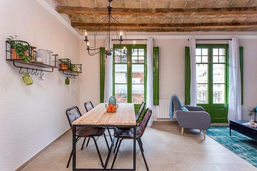 a dining room with a wooden table and chairs at Stay U-nique Apartments Fira BCN in Hospitalet de Llobregat
