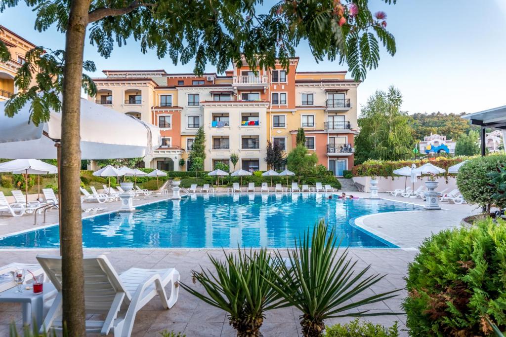 a large swimming pool in front of a building at Lily Beach Resort in Sozopol