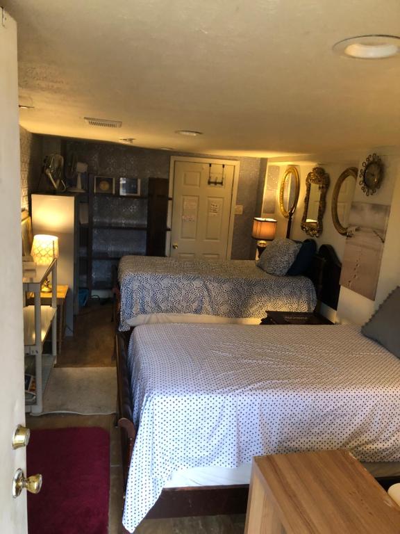 a bedroom with two beds and a table with a desk at Highland Park Pittsburgh in Pittsburgh