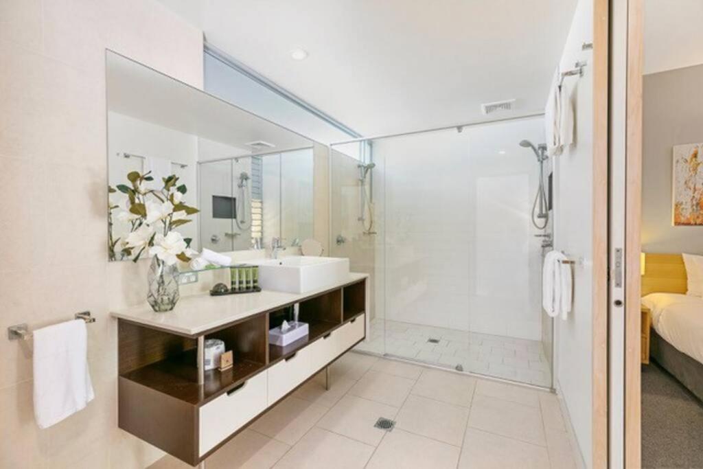 a bathroom with a sink and a shower at 9408 Luxury Apartment Close to Hastings Street in Noosa Heads