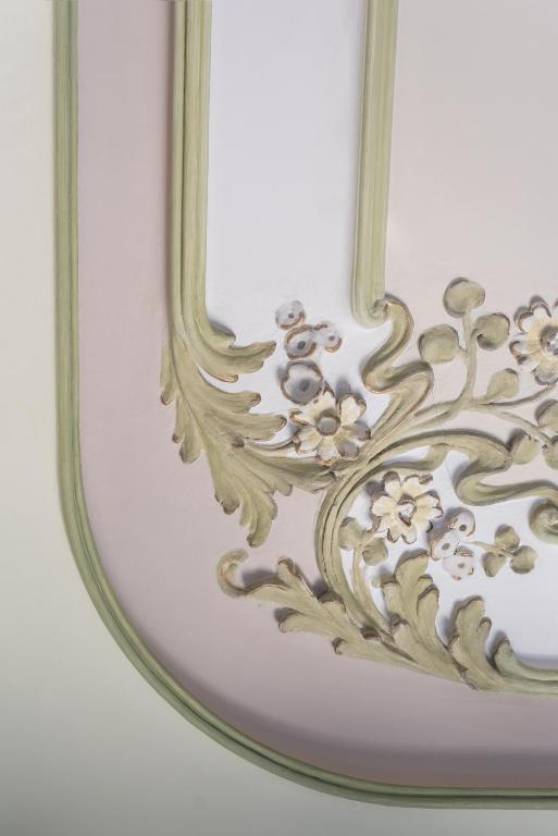 a mirror with a floral design on it at El Palauet Royal Suites in Barcelona