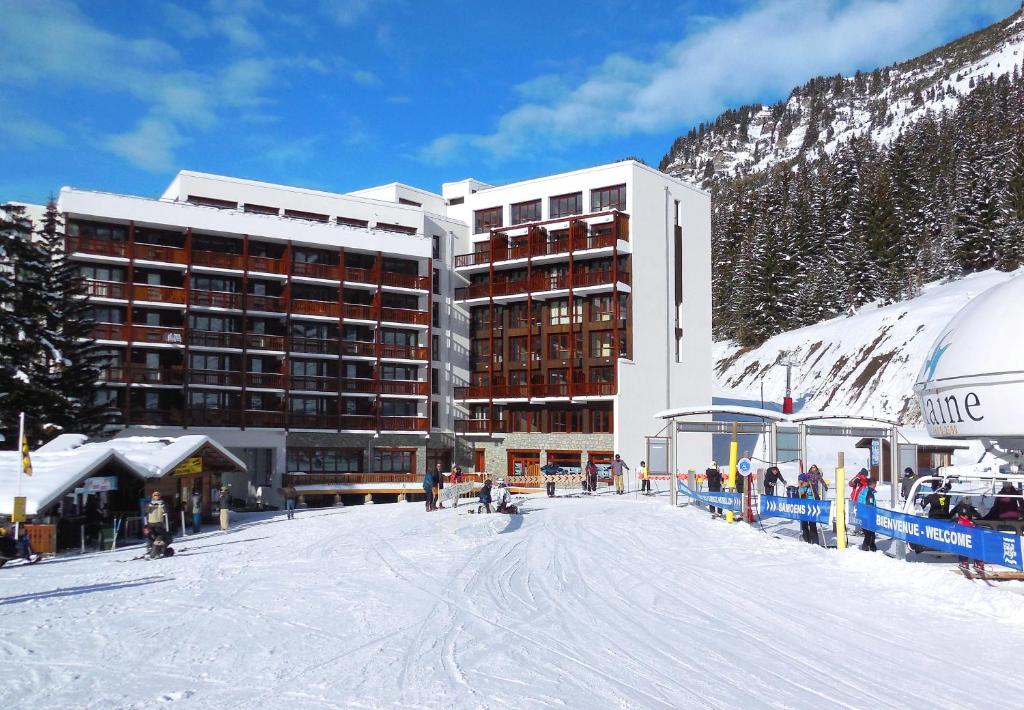 a large building with a ski slope in the snow at Résidence Odalys Le Panoramic in Flaine