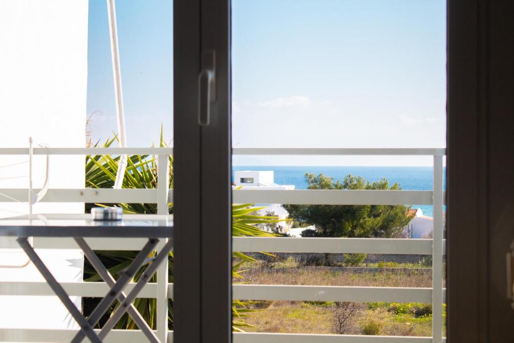 a view of the ocean from a window at EMVI APARTMENTS III seaview near airport in Artemida