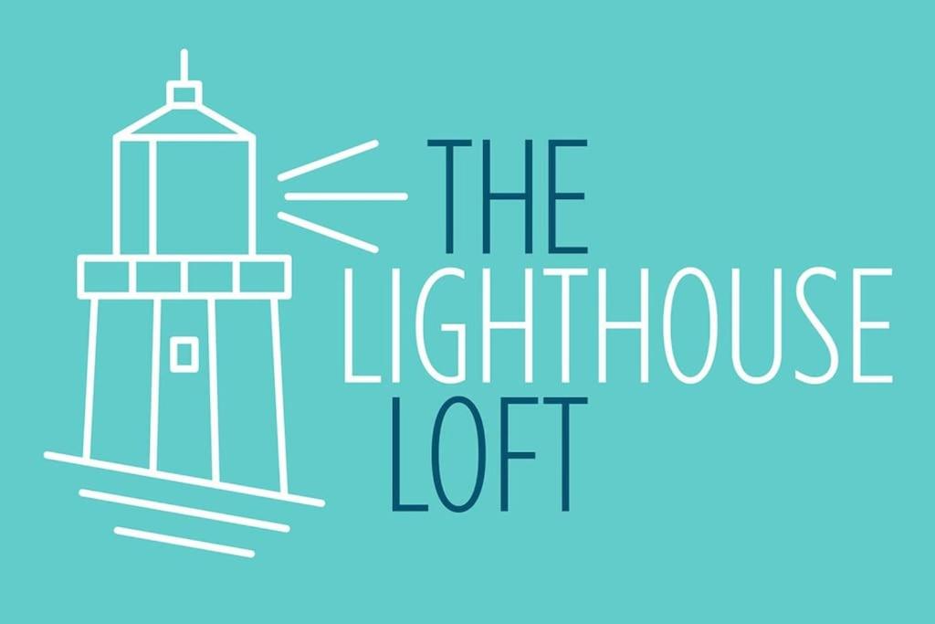a lighthouse with the text the lighthouse lot at The Lighthouse Loft in Whitehead