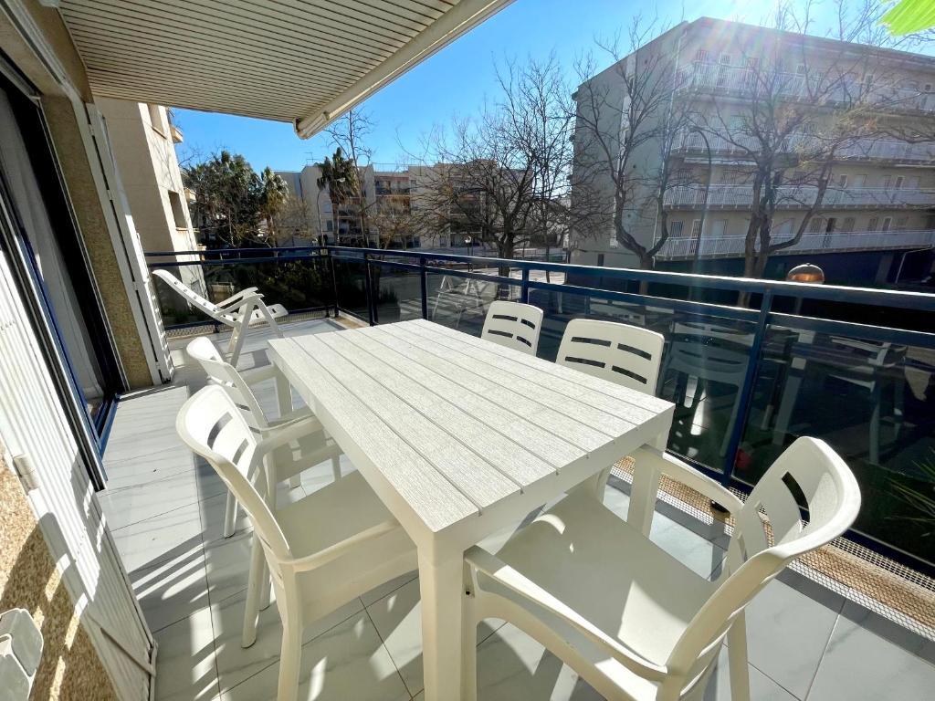 a white table and chairs on a balcony at Maria Voramar in Cambrils