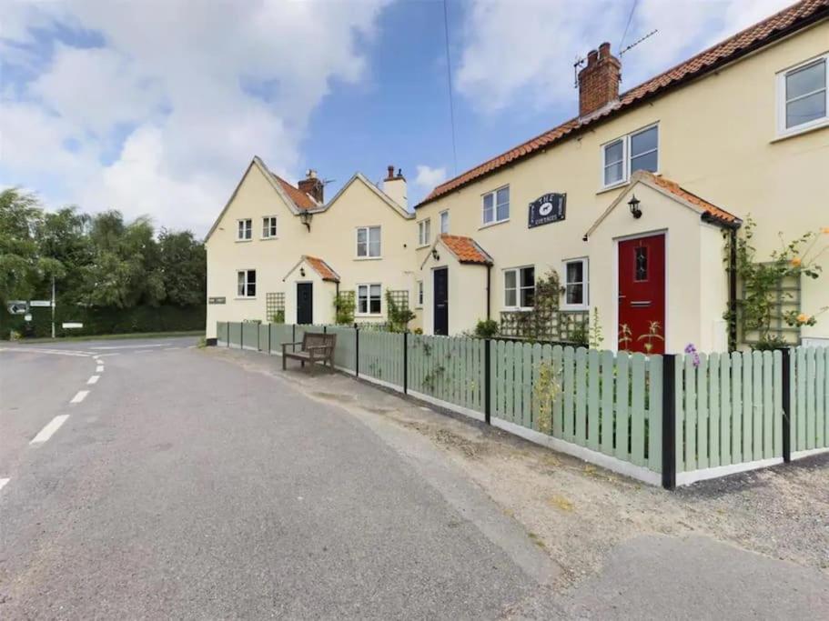 a house with a fence on the side of a road at Two Bedroomed House near Newark & Grantham 