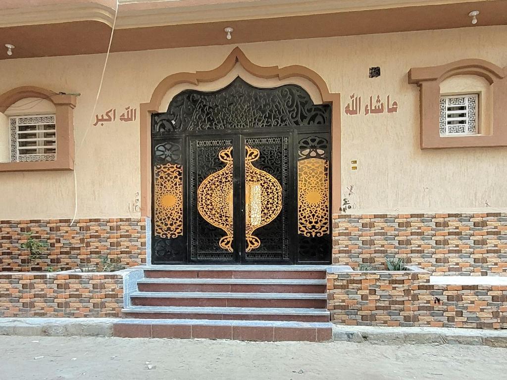 a black door on the side of a house at Ahmed House in Safaga