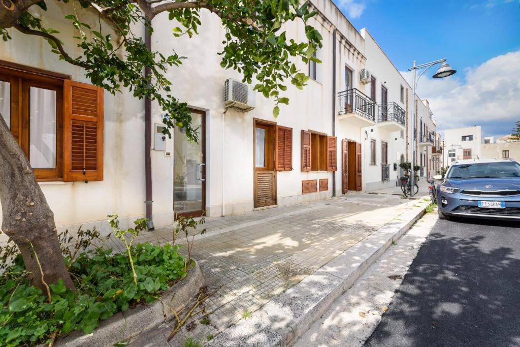 a car parked on a street next to a building at CasaVacanzeAurora in San Vito lo Capo