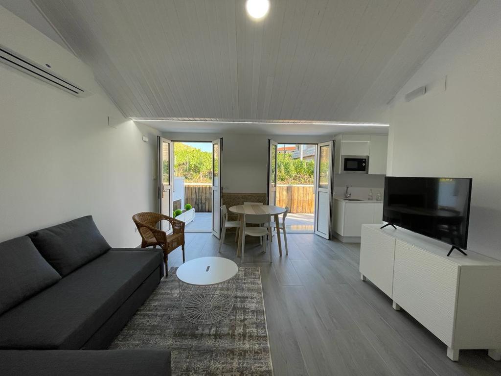 a living room with a couch and a table at Cepas Da Cuenga in Ribadavia