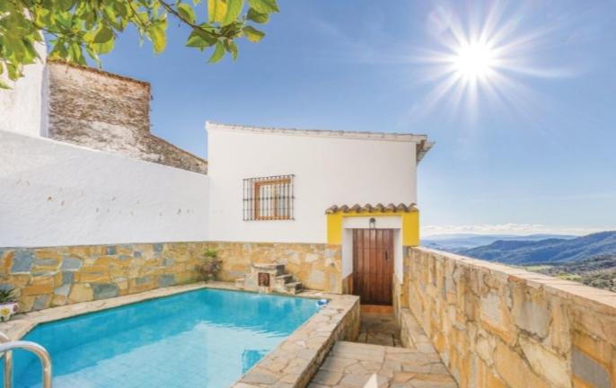 a swimming pool in front of a house at Casa El Limon in Gaucín