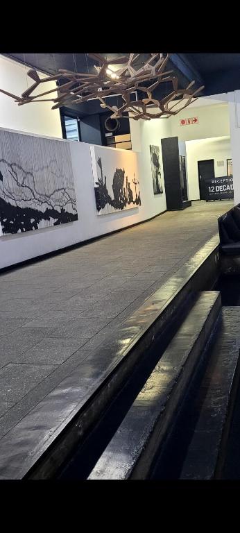 a empty hall in a building with photographs on the wall at Gorgeous in Johannesburg