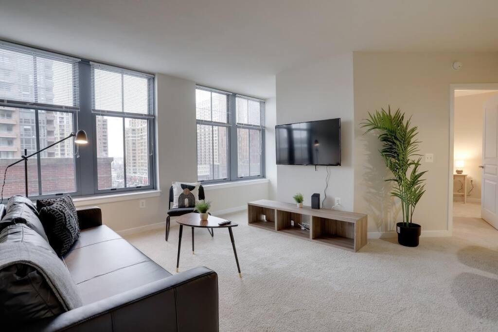 a living room with a couch and a tv at Beautiful 2 BR Apartment At Pentagon City With Gym in Arlington