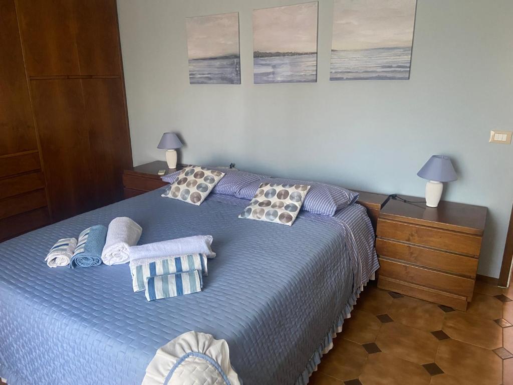 a bedroom with a blue bed with towels on it at La casa di Nana’ in Pisa