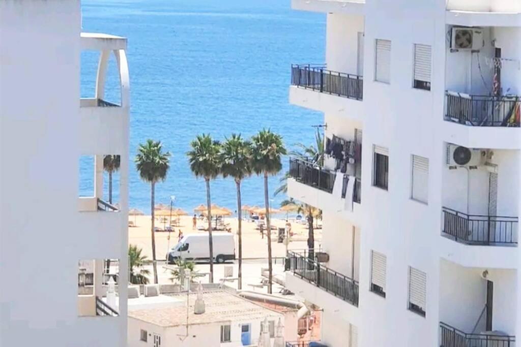 - une vue sur la plage depuis un immeuble dans l'établissement Quarteira Beach Vacation: 2BR steps to the sand, à Quarteira