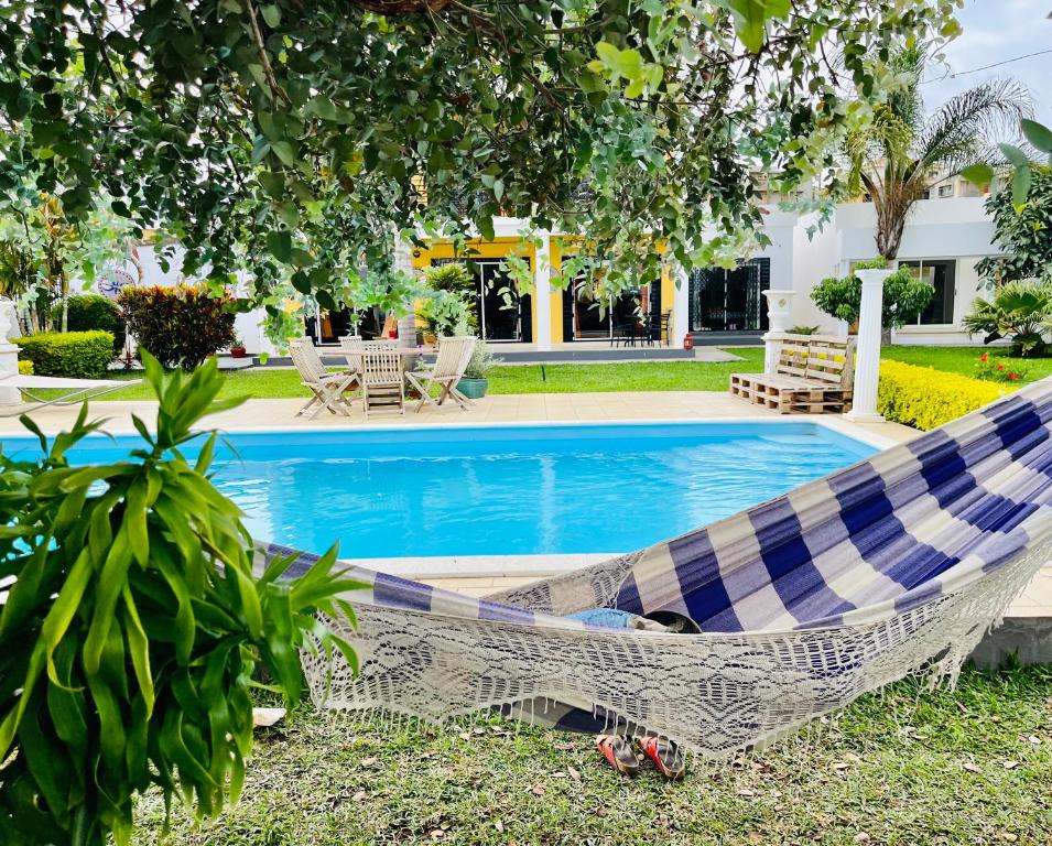 a hammock in front of a swimming pool at COCODY ROC in Ambohidratrimo