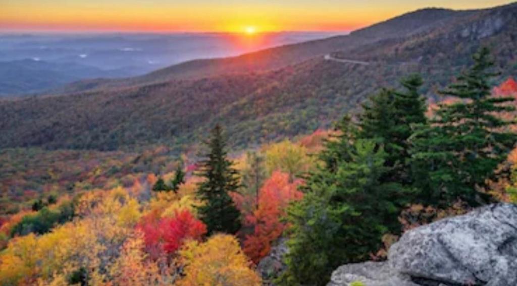 a view of a mountain with a sunset in the background at Dollywood Vacation Retreat in Pigeon Forge