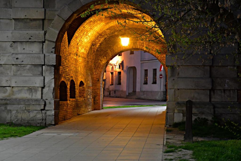 an archway leading to a building with a street at Apartament - Sienkiewicza 22D in Zamość
