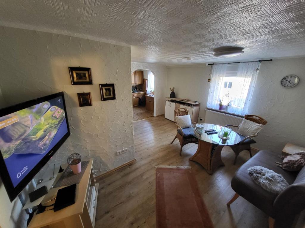 a living room with a couch and a table at Ferienwohnung Haus Luzia in Düngenheim