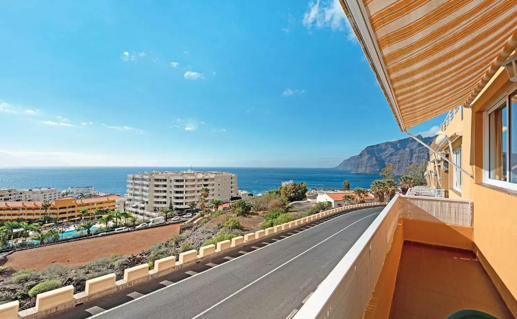 a road with a view of the ocean from a building at Apartamento en Los Gigantes, Tenerife in Puerto de Santiago