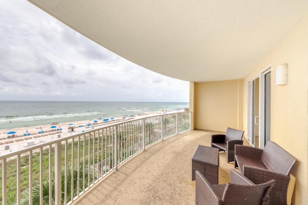 a balcony with chairs and a view of the beach at Ocean Villa 406 in Panama City Beach