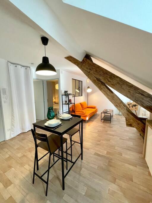- un salon avec une table et un canapé dans l'établissement Appartement Cosy Hyper centre WIFI, à Rodez