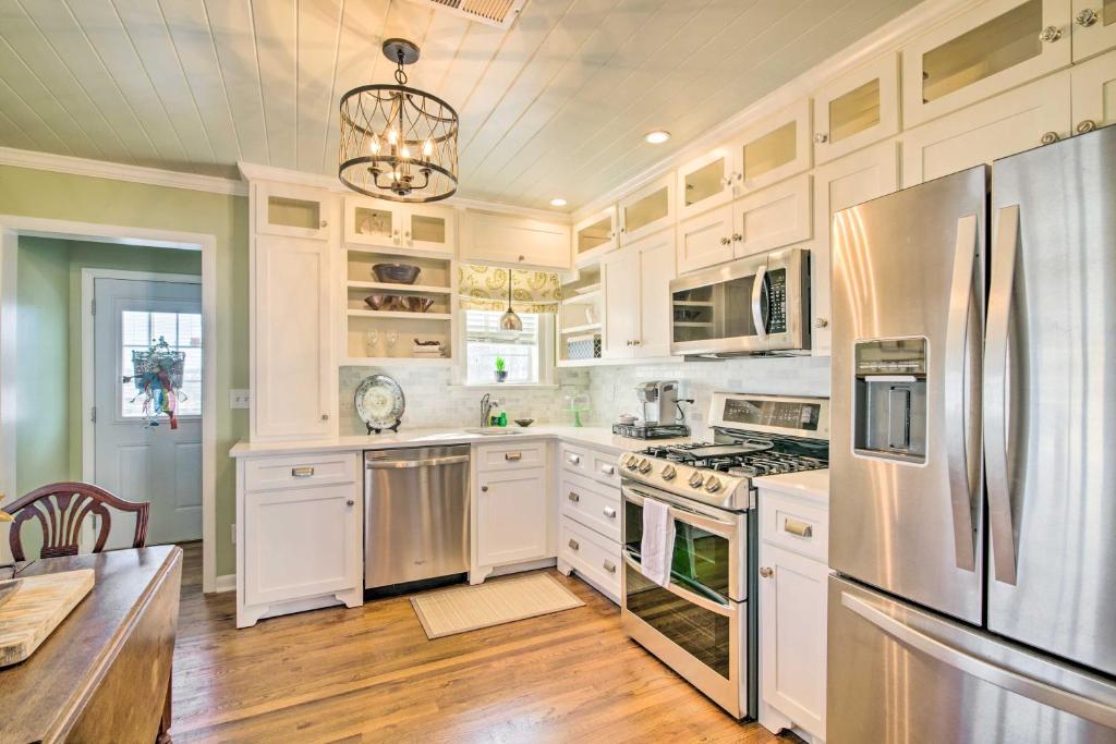 a kitchen with white cabinets and stainless steel appliances at Mississippi Cottage about 6 Mi to Columbus Lake in Columbus