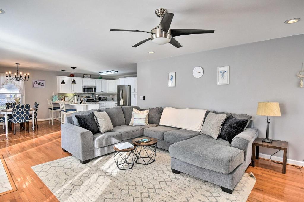 a living room with a couch and a ceiling fan at Norfolk Beach House Rental with Private Pool! in Norfolk