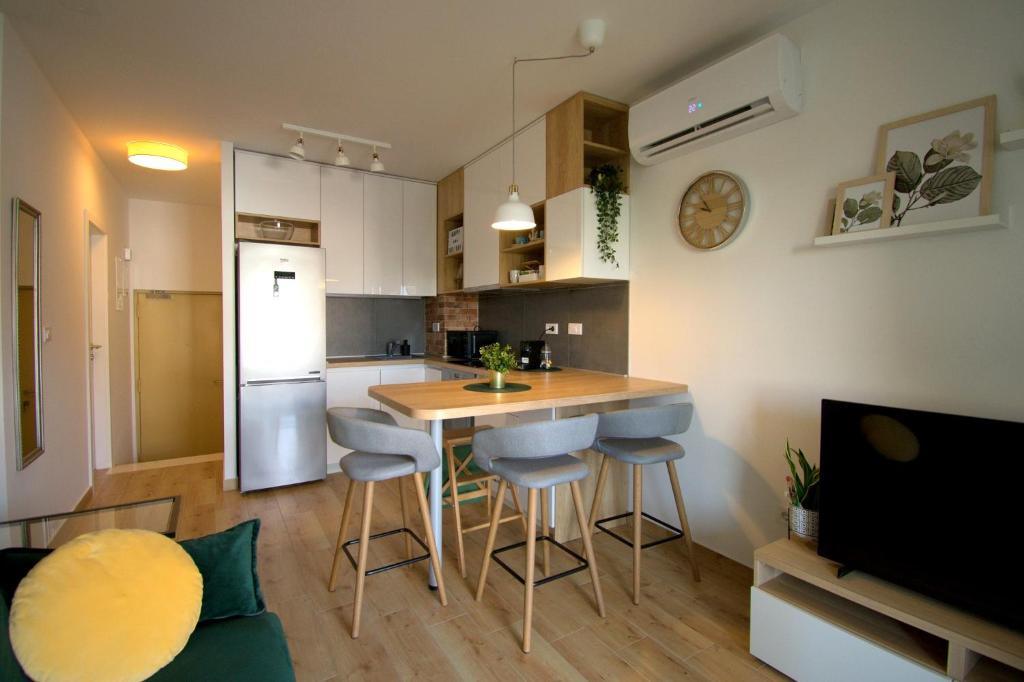 a kitchen with a table and stools in a room at Apartment Nikola in Split