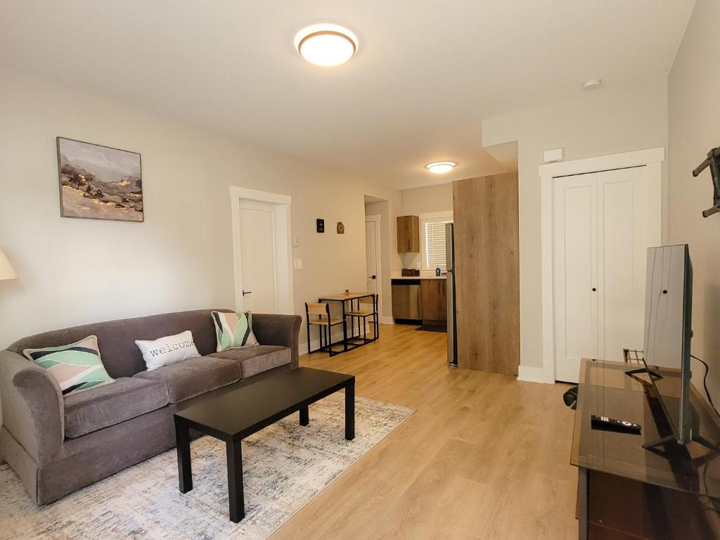a living room with a couch and a table at Feel like Home! in Langford