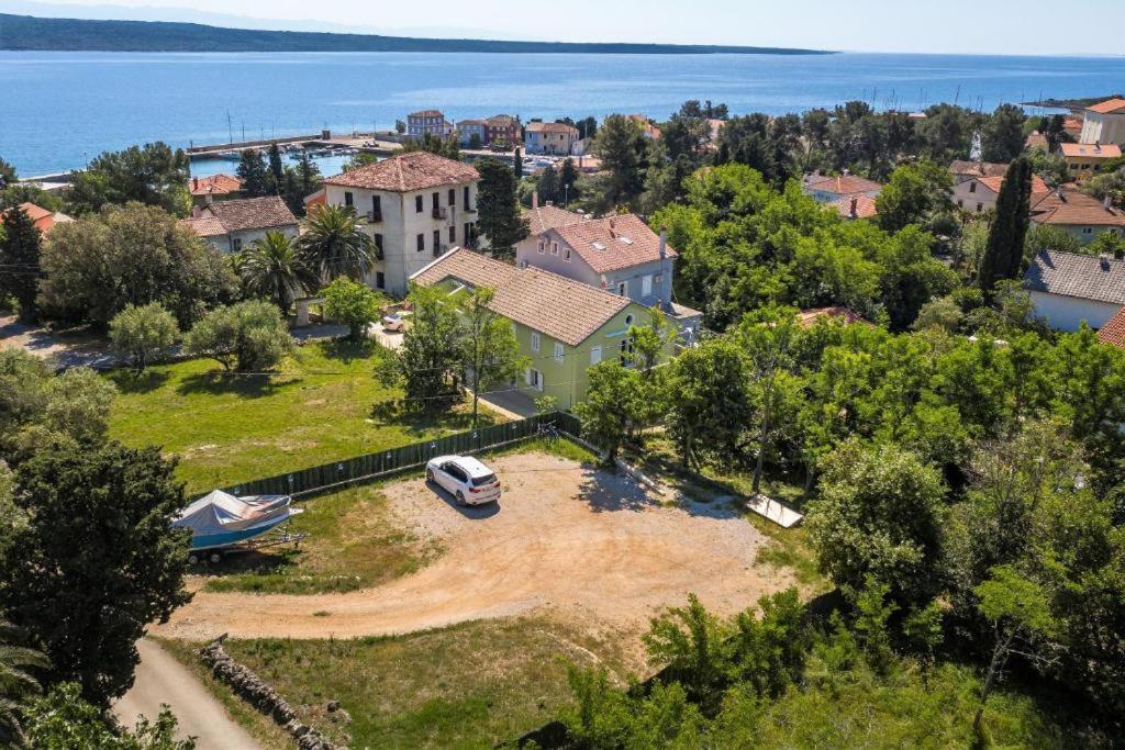 an aerial view of a house with a car parked in a yard at Meer in Nerezine