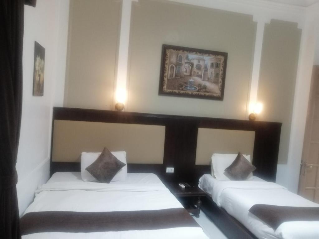 Postel nebo postele na pokoji v ubytování Gardenia Hotel