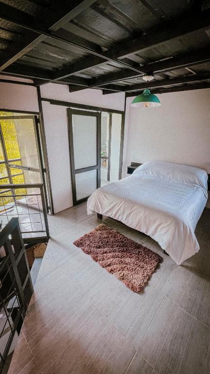 Postel nebo postele na pokoji v ubytování INLOFT Quindío
