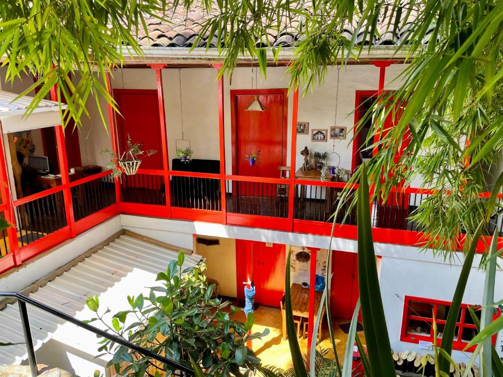 a house with red doors and a balcony at Hostal Tralala Salento in Salento