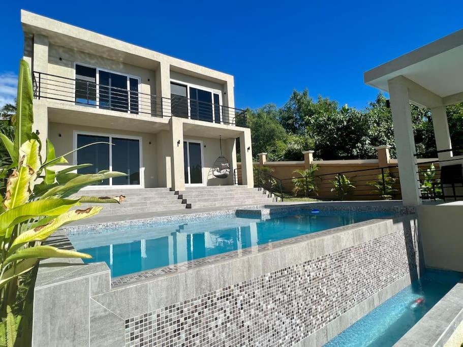 a swimming pool in front of a house at The Indianna ~ Luxury Pool & Spa in Whitehouse