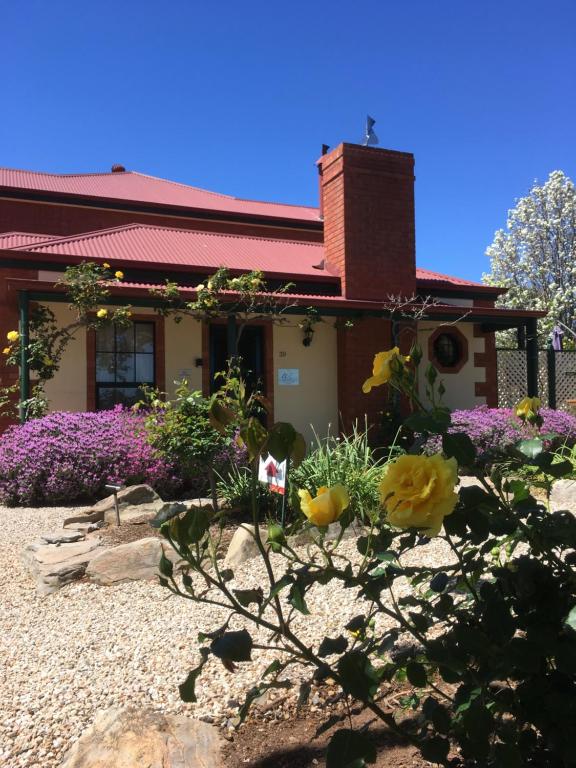 a house with flowers in front of it at Wine and Roses Bed and Breakfast in McLaren Vale