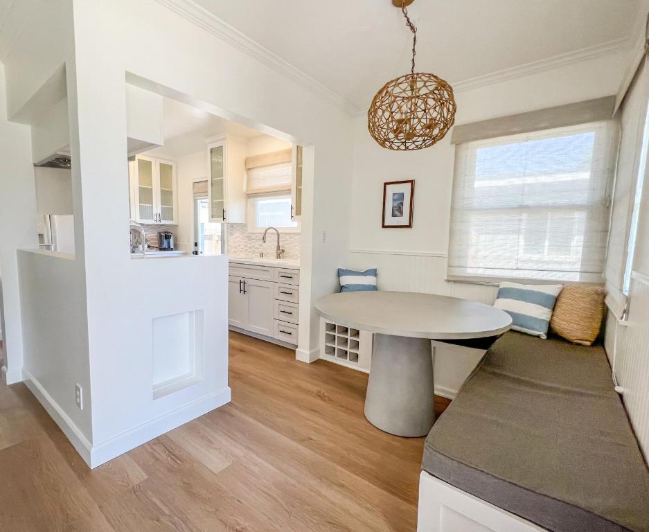 a kitchen and dining room with a table and a window at El Nido Beachlife Cottage in South Bay Los Angeles in Redondo Beach