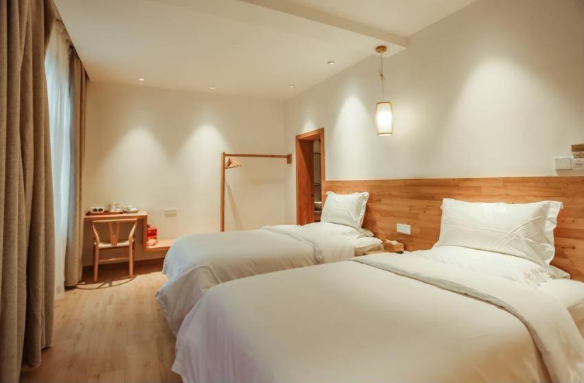 Postel nebo postele na pokoji v ubytování Villa EN Emerald Valley, Huangshan