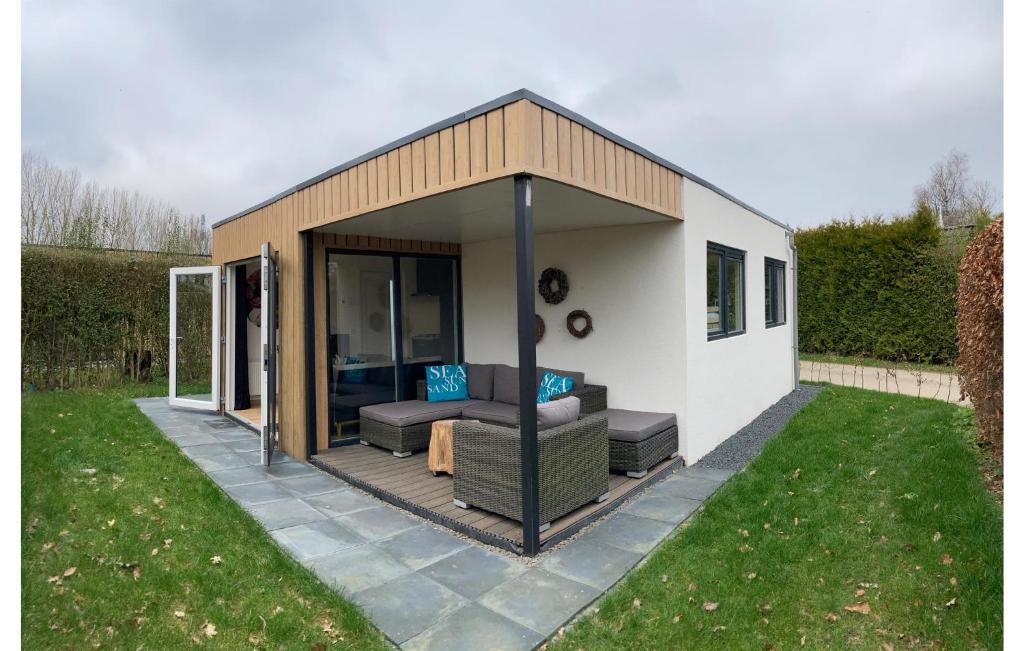 a small shed with a couch and a patio at 2 Bedroom Lovely Home In Heinkenszand in Heinkensand