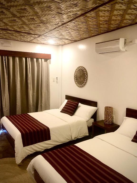 Postel nebo postele na pokoji v ubytování Yumi Villas