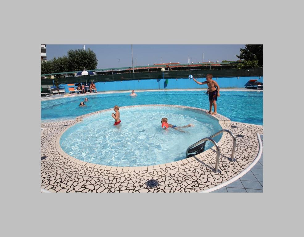 a group of people in a swimming pool at Hotel Ambassador in Caorle